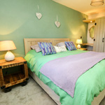 double bed with purple and green theme