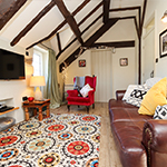 cadair freichiau goch wrth ymyl ffenestr