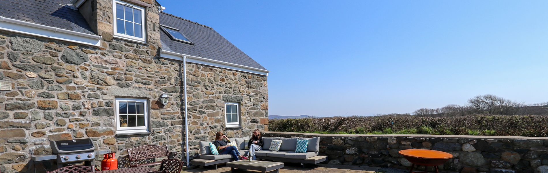 2 people sitting outside in the sun
