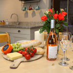 gwin, bwyd a blodau wedi arddangos ar y bwrdd