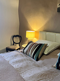 bedroom with double bed and a lamp in the corner